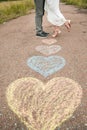 Heart symbols shaped with crayons on ground