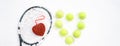 Heart of tennis balls and red heart on tennis racket on white snow winter background. Love Valentines day concept with tennis Royalty Free Stock Photo