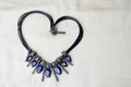 Heart to Valentine`s Day from a beautiful, feminine, fashionable necklace on a black rubber band with blue shining gems, diamonds Royalty Free Stock Photo