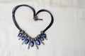 Heart to Valentine`s Day from a beautiful, feminine, fashionable necklace on a black rubber band with blue shining gems, diamonds Royalty Free Stock Photo