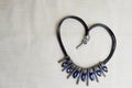 Heart to Valentine`s Day from a beautiful, feminine, fashionable necklace on a black rubber band with blue shining gems, diamonds Royalty Free Stock Photo