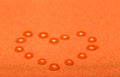 Heart from water drops on an orange background Royalty Free Stock Photo