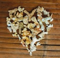 Heart from white corals on wooden background. VIntage love decor from beach finding.