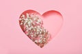 Heart with white flowers on a pink background. Flowers inside the heart. Postcard, greetings for March 8, St. Valentine\'s Da