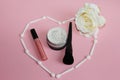 Heart of white shadow applicators on a pink background inside the heart powder and black powder brush Royalty Free Stock Photo