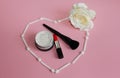 Heart of white shadow applicators on a pink background inside the heart red lipstick Royalty Free Stock Photo