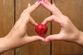 A heart from a woman`s hands. in the center of which is a strawberry berry Royalty Free Stock Photo