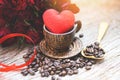 Heart in wooden coffee cup with coffee beans romantic love valentines day and red rose flower on wood background - love coffee Royalty Free Stock Photo