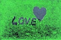 The heart and the word love concept. on a green background Royalty Free Stock Photo