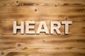 HEART word made with building blocks on wooden board