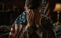 A heart-wrenching scene of a young soldier in distress, his hands covering his face, and the American flag draped around