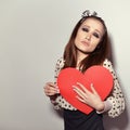 Heartbreaker. Temptress. Seductive woman. Portrait of funny pinup young fashion woman posing at studio with red heart. Love. Royalty Free Stock Photo