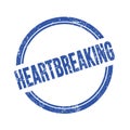 HEARTBREAKING text written on blue grungy round stamp