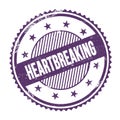 HEARTBREAKING text written on purple indigo grungy round stamp