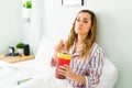 Heartbroken woman eating ice cream in bed Royalty Free Stock Photo