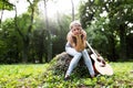 Heartbroken woman in nature with guitar Royalty Free Stock Photo