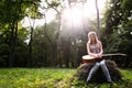 Heartbroken woman in nature with guitar Royalty Free Stock Photo