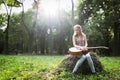 Heartbroken woman in nature with guitar Royalty Free Stock Photo