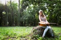 Heartbroken woman in nature with guitar Royalty Free Stock Photo