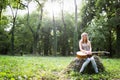 Heartbroken woman in nature with guitar Royalty Free Stock Photo