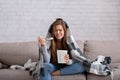 Heartbroken young woman eating ice cream from bucket while watching romantic movie on TV, feeling depressed and lonely Royalty Free Stock Photo