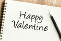 A heartfelt Happy Valentine message written in script on a white spiral notebook Royalty Free Stock Photo