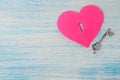 Hearts with a keyhole and key on the blue wooden background. view from above. Valentine`s Day. space for text Royalty Free Stock Photo
