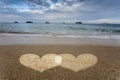 Hearts Light in Sand on Ocean Beach. Royalty Free Stock Photo