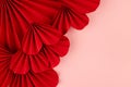 Hearts love background for marriage celebration - beautiful red paper ribbed hearts in simple origami style on pastel pink color. Royalty Free Stock Photo