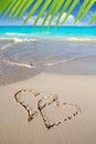 Hearts in love written in Caribbean beach sand