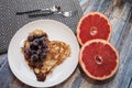 Hearts pancakes with blackberries on a white plate. blue wooden Background with grapefruit. Romantic or healthy