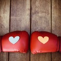 Hearts on red boxing gloves on wood. Conceptual image of fight f Royalty Free Stock Photo
