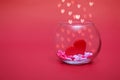 Hearts in a round transparent vase on a red bokeh background with hearts. Valentine's day or mother's day Royalty Free Stock Photo