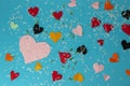 hearts of various sizes and colors on a blue background covered with petals, love design for greeting cards, flat design