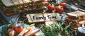 A Heartwarming Family Picnic Scene With Sandwiches Spelling Family Time