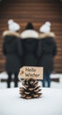 A heartwarming Hello Winter message on a pinecone nestled in fresh snow with friends Royalty Free Stock Photo