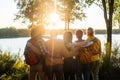 Sunset Comradeship: Friends United by Lakeside Views Royalty Free Stock Photo