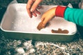 moment unfolds in kitchen as a mom and son engage in tradition of preparing Christmas gingerbread.