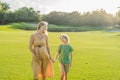 Heartwarming outdoor bonding as a pregnant mom and her son enjoy quality time together, savoring the beauty of nature Royalty Free Stock Photo