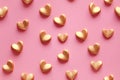 A heartwarming pattern of 3D golden hearts on a pastel pink background, perfect for themes of love, Valentine's Day