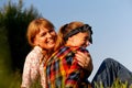 A heartwarming portrait of a mother and daughter sharing a tender cuddle outdoors on a sunny summer day, radiating Royalty Free Stock Photo