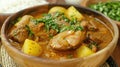 Hearty beef stew in a wooden bowl with potatoes and garnished with parsley Royalty Free Stock Photo