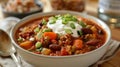 A hearty bowl of chili made with lean ground turkey beans and vegetables topped with a dollop of Greek yogurt and