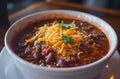 Hearty Bowl of Chili Topped with Cheese and Parsley