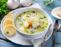 hearty bowl of Cullen Skink, a traditional Scottish soup, served with grilled bread on a rustic wooden table, suggesting a