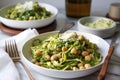 hearty bowl of zucchini pasta with pesto and chickpeas