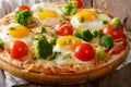 Hearty breakfast of pizza with eggs, broccoli, tomatoes closeup