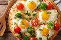 Hearty breakfast of pizza with eggs, broccoli, tomatoes closeup Royalty Free Stock Photo
