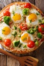 Hearty breakfast of pizza with eggs, broccoli, tomatoes closeup Royalty Free Stock Photo