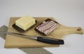 Hearty cheese and bacon sandwiches on a wooden chopping board and kitchen knife. The concept of making a quick snack Royalty Free Stock Photo